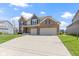Two-story brick home with a spacious driveway and attached two-car garage at 419 Dovetree Dr, Danville, IN 46122
