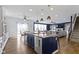 Spacious kitchen with island featuring bar stool seating that opens to the dining and living area at 419 Dovetree Dr, Danville, IN 46122
