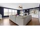 Bright living room with large windows, a comfortable sectional, and built-in shelving at 419 Dovetree Dr, Danville, IN 46122