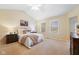 Spacious bedroom featuring a ceiling fan, two windows, a bed with a plush blanket, and a dark wood dresser at 442 Athens Pl, Westfield, IN 46074
