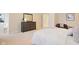 Well-lit bedroom with a large bed, dresser, and a cozy chair next to a small table at 442 Athens Pl, Westfield, IN 46074