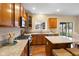 Well-equipped kitchen featuring an island with seating, granite countertops, stainless appliances, and hardwood floors at 442 Athens Pl, Westfield, IN 46074