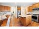 Bright and open kitchen with stainless steel appliances, granite countertops, and wood cabinets, open to dining area at 442 Athens Pl, Westfield, IN 46074