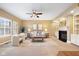 Comfortable living room features a fireplace, large windows, neutral tones, and ample seating for relaxation at 442 Athens Pl, Westfield, IN 46074
