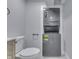 The half bath includes a toilet next to the stackable washer and dryer unit at 451 N Gray St, Indianapolis, IN 46201