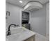 Modern bathroom features a stackable washer and dryer, marble vanity, and sleek, black faucet at 451 N Gray St, Indianapolis, IN 46201