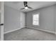 Bright bedroom with a window featuring gray walls and carpet with white trim and door at 451 N Gray St, Indianapolis, IN 46201
