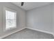 Bedroom featuring gray walls and carpet, white trim, and a large window bringing in natural light at 451 N Gray St, Indianapolis, IN 46201