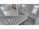 Entryway with a carpeted staircase and wood-look floors in the entry and living room at 451 N Gray St, Indianapolis, IN 46201