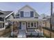 Charming two-story home with a welcoming front porch and beautifully landscaped yard at 451 N Gray St, Indianapolis, IN 46201