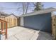 View of the backyard featuring a one car garage, wood fence, and concrete patio at 451 N Gray St, Indianapolis, IN 46201