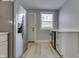 Bright kitchen featuring stainless steel appliances, white cabinets, wood-look floors, and a window at 451 N Gray St, Indianapolis, IN 46201