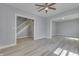 Spacious living room featuring hardwood floors, light gray walls, and a view to the foyer and another room at 451 N Gray St, Indianapolis, IN 46201