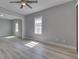 Open-concept living area with wood floors, light gray walls, and ample space for furnishings at 451 N Gray St, Indianapolis, IN 46201