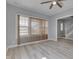Open-concept living room with wood floors, abundant natural light, and a view of the staircase at 451 N Gray St, Indianapolis, IN 46201