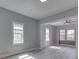 Open-concept living room with gray walls, wood-look floors, and an open archway leading into another living space at 451 N Gray St, Indianapolis, IN 46201