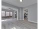 Spacious living room featuring gray walls, wood-look floors, and open to the kitchen and entry at 451 N Gray St, Indianapolis, IN 46201