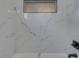 Close-up of the shower wall featuring marble-style tile with a dark accent at 451 N Gray St, Indianapolis, IN 46201