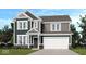 Two-story home featuring a two-car garage, neutral siding, brick accents, and a covered front porch at 4774 E Summerfield Dr, Camby, IN 46113