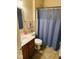 Standard bathroom with a vanity, toilet, and a shower behind a blue curtain at 4871 Franklin Villas Dr, Indianapolis, IN 46237