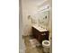 Bathroom with a double sink vanity, well-lit mirror, and tiled flooring at 4871 Franklin Villas Dr, Indianapolis, IN 46237