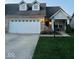 Charming brick home featuring a manicured lawn and a convenient two-car garage at 4871 Franklin Villas Dr, Indianapolis, IN 46237