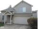Charming two-story home with a well-manicured lawn and attached two-car garage offering curb appeal at 4959 Clarkson Dr, Indianapolis, IN 46254