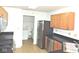 Modern kitchen with stainless steel appliances, oak cabinets, and a convenient laundry area at 4959 Clarkson Dr, Indianapolis, IN 46254