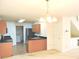 An open kitchen with wooden cabinets and stainless steel appliances, plus a view to the laundry area at 4959 Clarkson Dr, Indianapolis, IN 46254