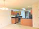 A kitchen with wood cabinets, stainless-steel appliances and a view to the dining area at 4959 Clarkson Dr, Indianapolis, IN 46254