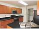 A kitchen features wood cabinets, black countertops, and stainless-steel appliances at 4959 Clarkson Dr, Indianapolis, IN 46254