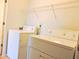 A laundry area with a washer, dryer, and wire rack for storage at 4959 Clarkson Dr, Indianapolis, IN 46254