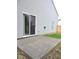 An open concrete patio extends from a home's sliding glass door, with a view of the fenced backyard at 4959 Clarkson Dr, Indianapolis, IN 46254