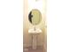 Powder room with pedestal sink, round mirror, and tile flooring at 4959 Clarkson Dr, Indianapolis, IN 46254