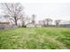 Large, grassy backyard with wooden fence, perfect for outdoor activities at 504 W Dwain, Shelbyville, IN 46176