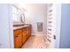 Bathroom featuring a double sink vanity, with tile flooring and ample cabinet space at 504 W Dwain, Shelbyville, IN 46176