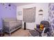 Bright Bedroom featuring a cozy glider chair, crib and playful decor accents at 504 W Dwain, Shelbyville, IN 46176