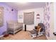 Charming Bedroom with crib, glider chair, and whimsical decorations on the walls at 504 W Dwain, Shelbyville, IN 46176