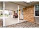 Inviting covered front porch with comfortable seating, brick exterior, and stylish entrance at 504 W Dwain, Shelbyville, IN 46176