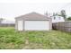 Detached garage with a large roll-up door and side door, located in the backyard at 504 W Dwain, Shelbyville, IN 46176