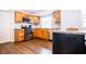 Charming kitchen with stainless appliances, wood cabinets, and a breakfast bar at 504 W Dwain, Shelbyville, IN 46176