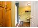 Well-organized laundry room featuring wooden storage cabinets, a washer, and a dryer, with storage shelves at 504 W Dwain, Shelbyville, IN 46176