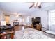 Open-concept living room featuring a large TV, hardwood floors, ceiling fan, and neutral paint at 504 W Dwain, Shelbyville, IN 46176