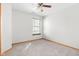 Bright, carpeted bedroom with ceiling fan and large window overlooking the yard at 5105 Hawks Crescent Ct, Indianapolis, IN 46254