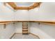 Spacious walk in closet featuring wood shelving and carpeted floor at 5105 Hawks Crescent Ct, Indianapolis, IN 46254