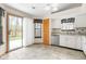 Well-lit kitchen area with access to the backyard and featuring stainless steel dishwasher at 5105 Hawks Crescent Ct, Indianapolis, IN 46254