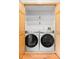 Convenient laundry area with modern front loading washer and dryer, plus shelving and ample space at 5105 Hawks Crescent Ct, Indianapolis, IN 46254