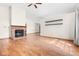 Bright living room features laminate floors, brick fireplace, ceiling fan, and neutral wall color at 5105 Hawks Crescent Ct, Indianapolis, IN 46254