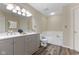Bathroom with double vanity sink, toilet, and tiled soaking tub at 518 Carthage Cir, Westfield, IN 46074