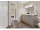 Bright bathroom featuring a dual sink vanity, wood-look floors, and a walk-in shower at 518 Carthage Cir, Westfield, IN 46074